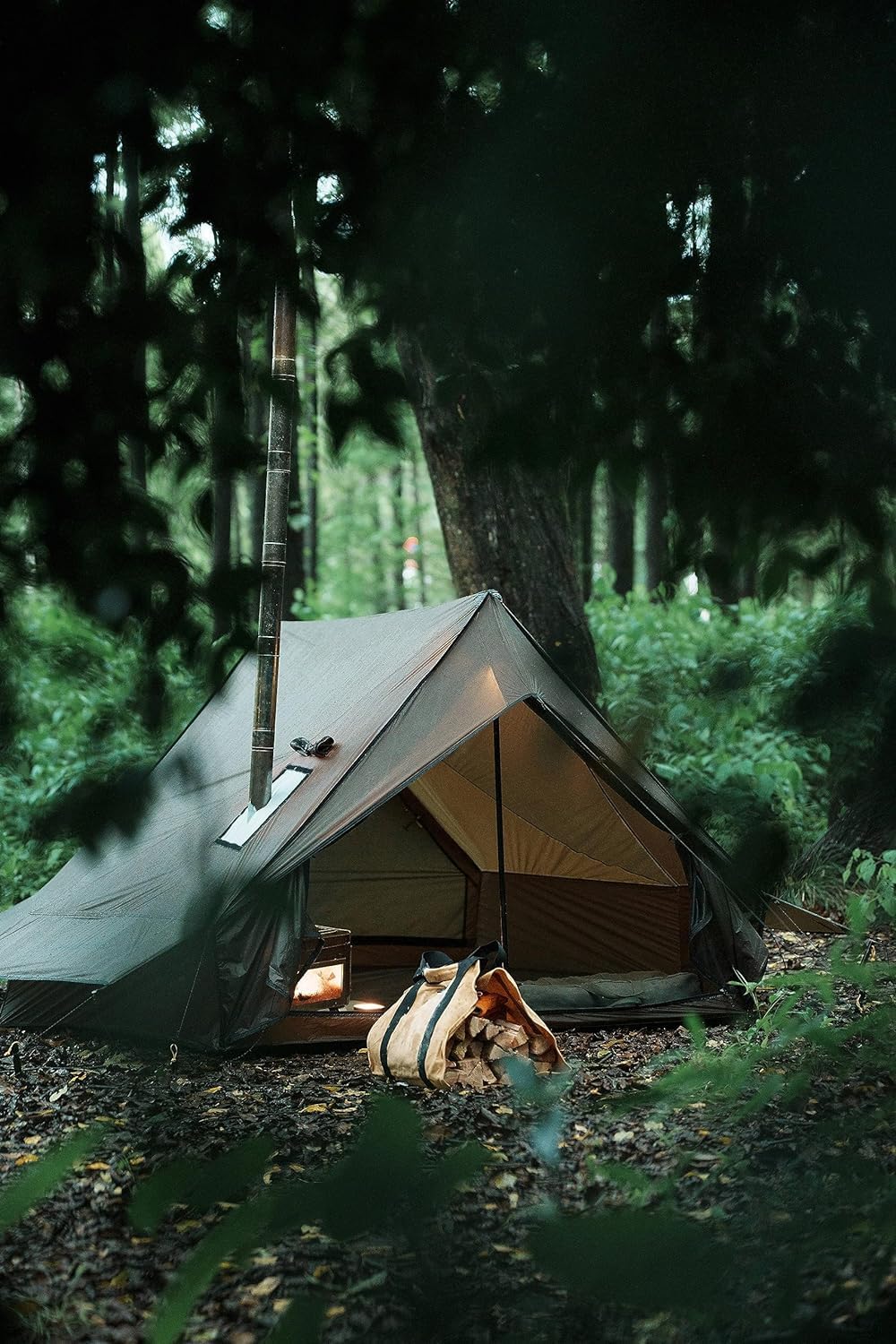 Dandelion Shell hot tent hardware featuring poles and stakes for quick setup.