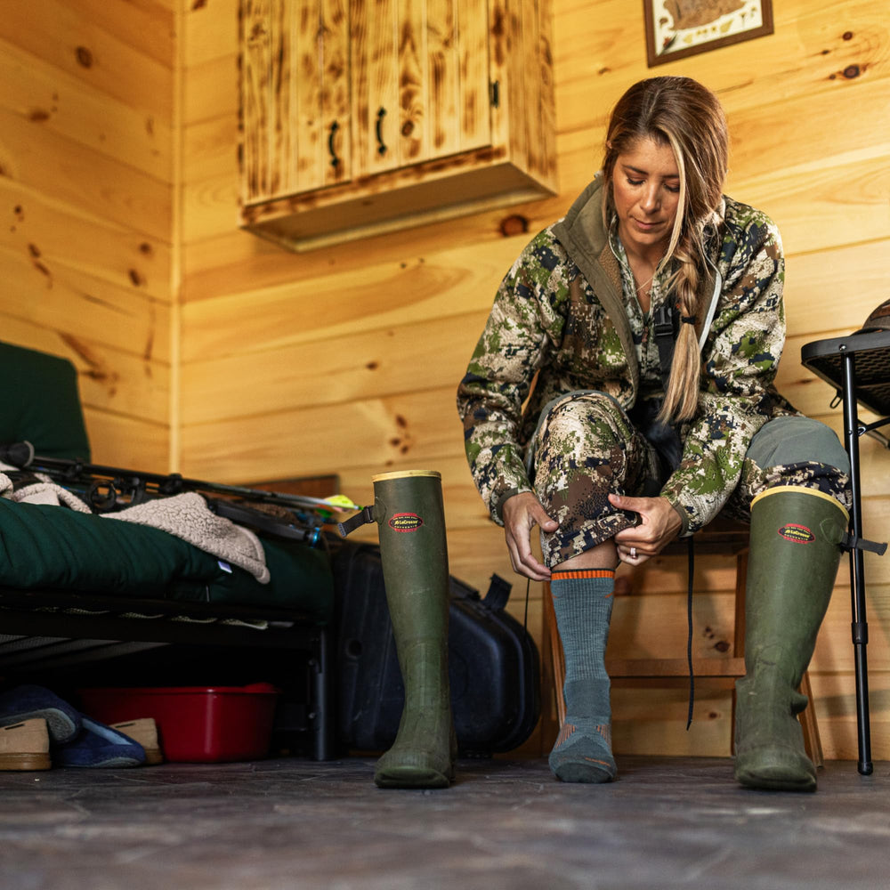 Darn Tough Vermont boot socks seafoam shown worn in rugged outdoor boots for hunting