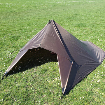 DD Hammocks DD Tarp 3x3 Coyote Brown between trees setup highlights versatile shelter options.