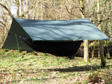 DD Hammocks Superlight Tarp being set up with a hammock for stormproof shelter