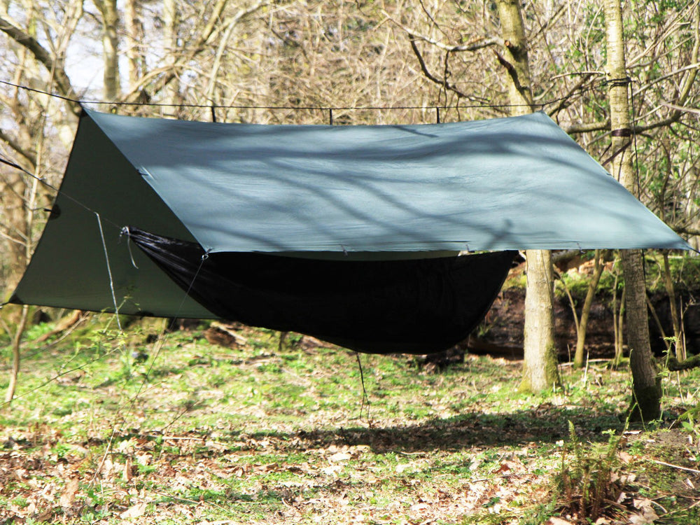 DD Hammocks Superlight Tarp being set up with a hammock for stormproof shelter