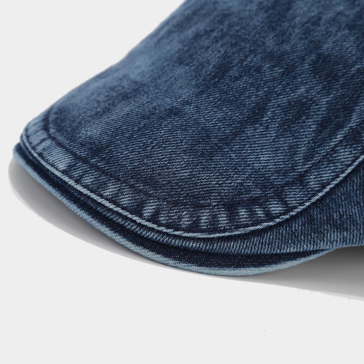 Adjustable strap detail on the denim newsboy cap