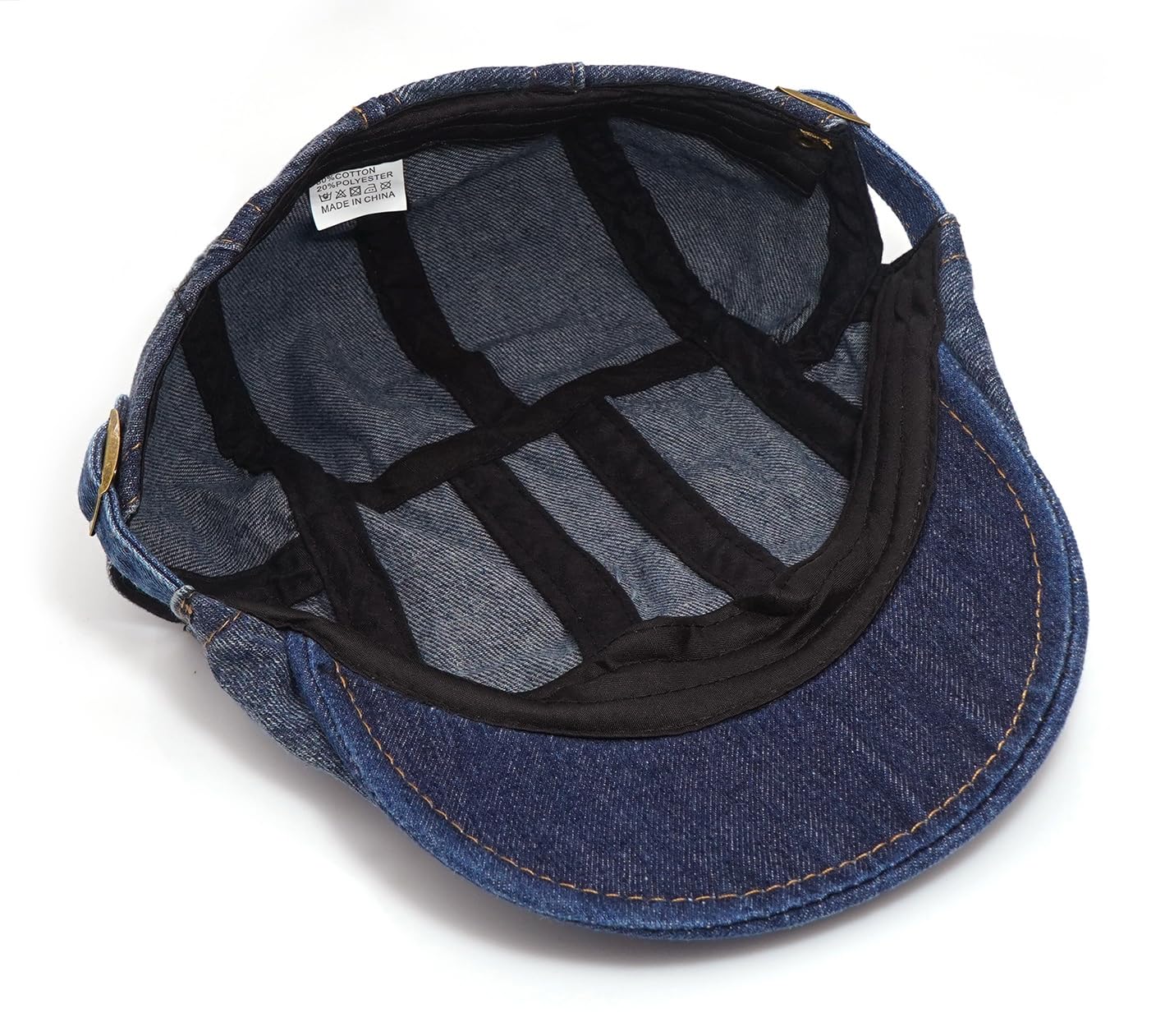Close-up of adjustable buckle on denim newsboy cap