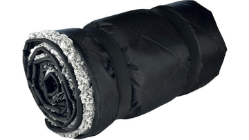 Down Under Outdoors 82x55 blanket shown with a stuff sack for travel storage.