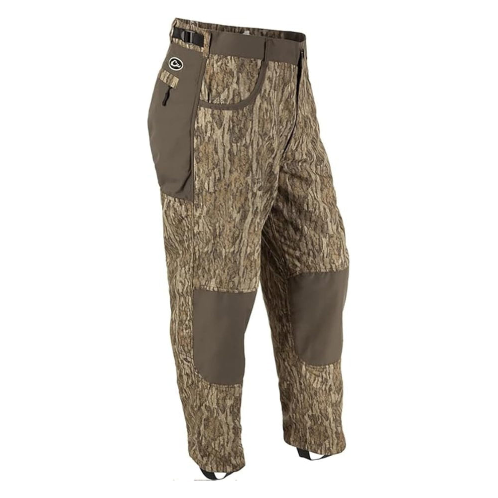 Drake Waterfowl MST jean-cut under-wader pants in Mossy Oak Bottomland pattern showing rugged camouflage texture for hunts.