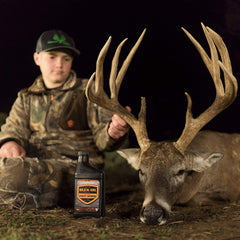 Elusive Wildlife Buck Oil attractant on feed pile inviting deer to approach