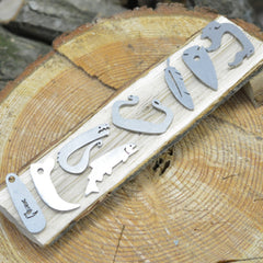 EmberLit pendant-ready arrow head steel design for wear and quick access.