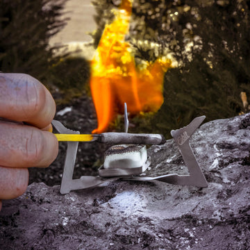 Esbit camping stove setup with 4g fuel tablets for quick heat.