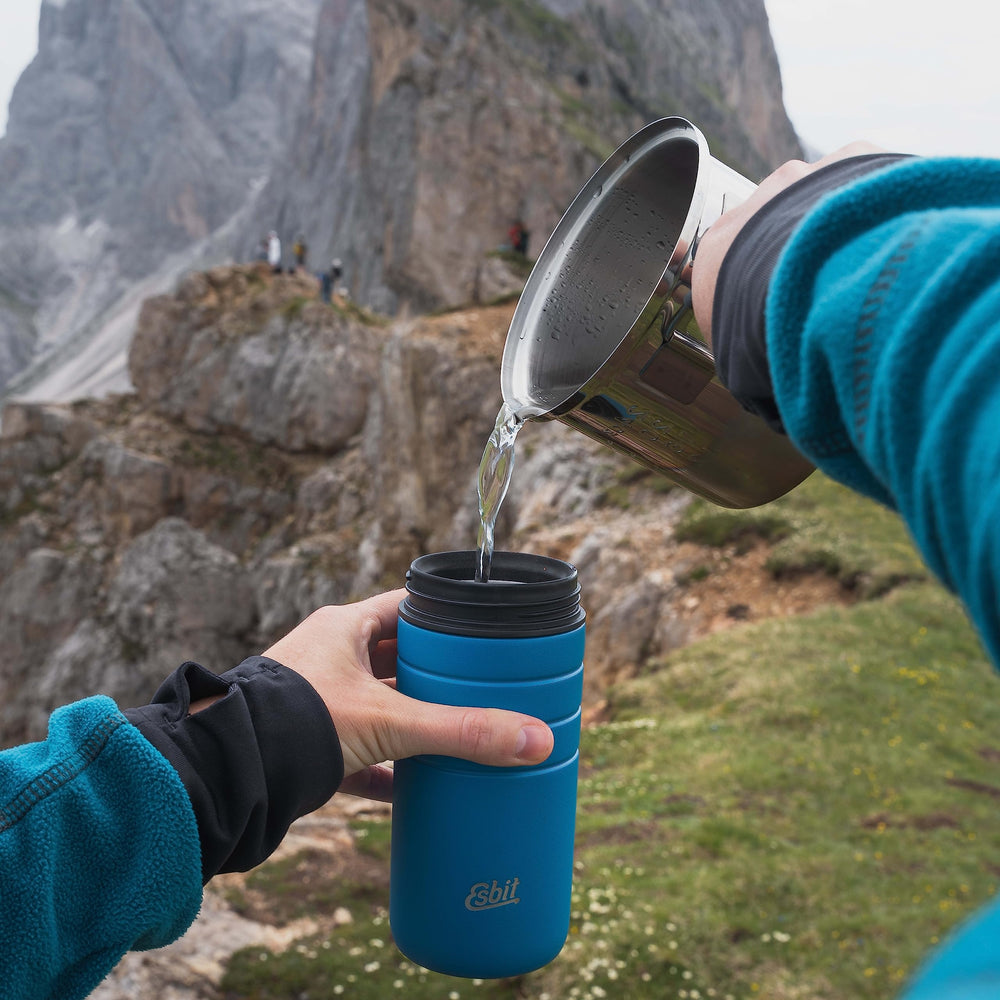 Esbit open pot with lid demonstrating versatile meal prep on trail.