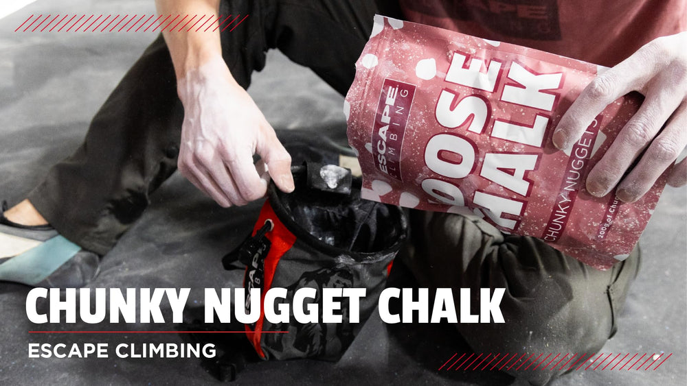 Escape Climbing Sick Dyno climber applying chalk to fingers for grip.
