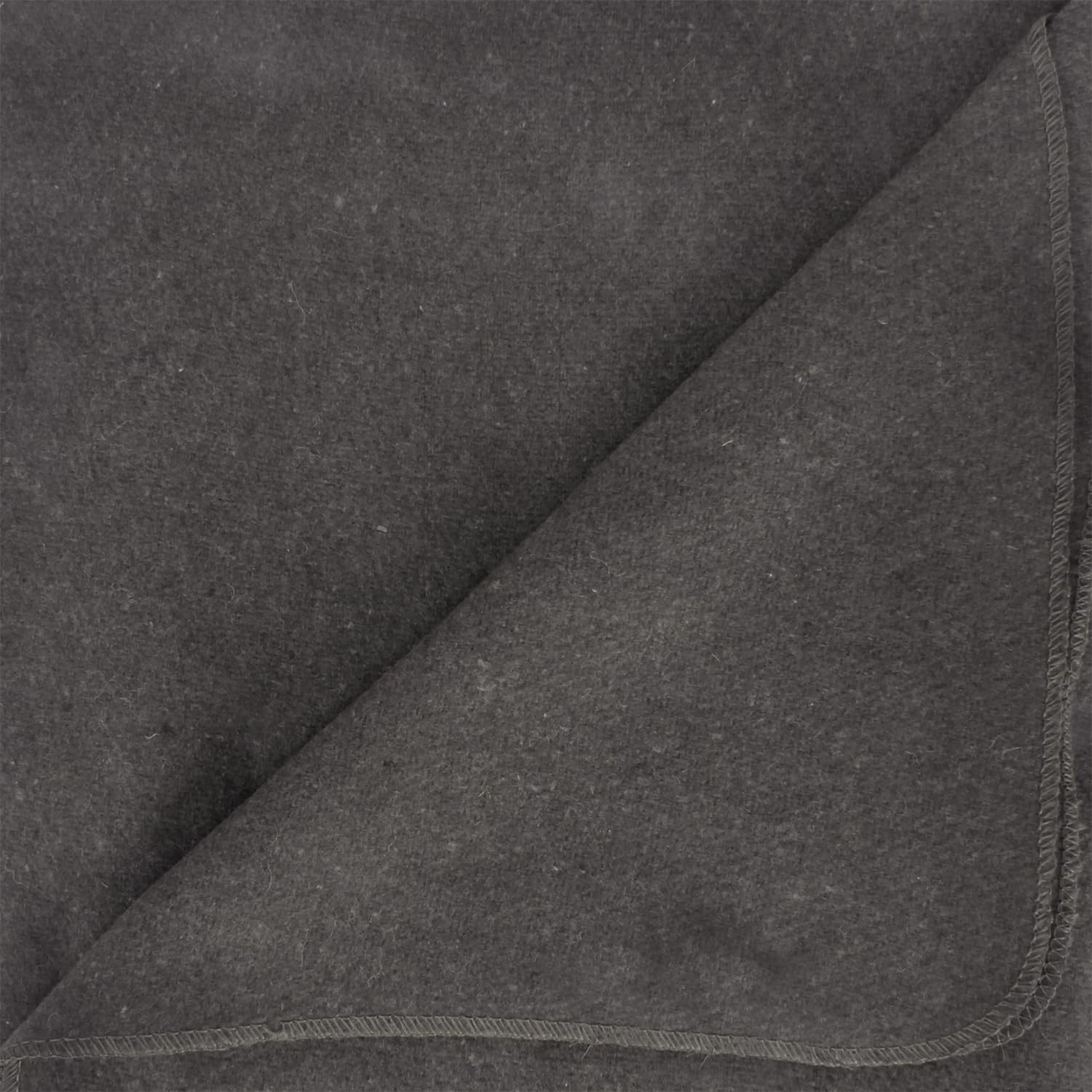 At campsite, the Ever Ready grey blanket sits near a campfire.