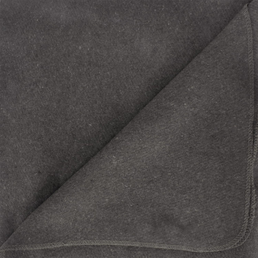 At campsite, the Ever Ready grey blanket sits near a campfire.