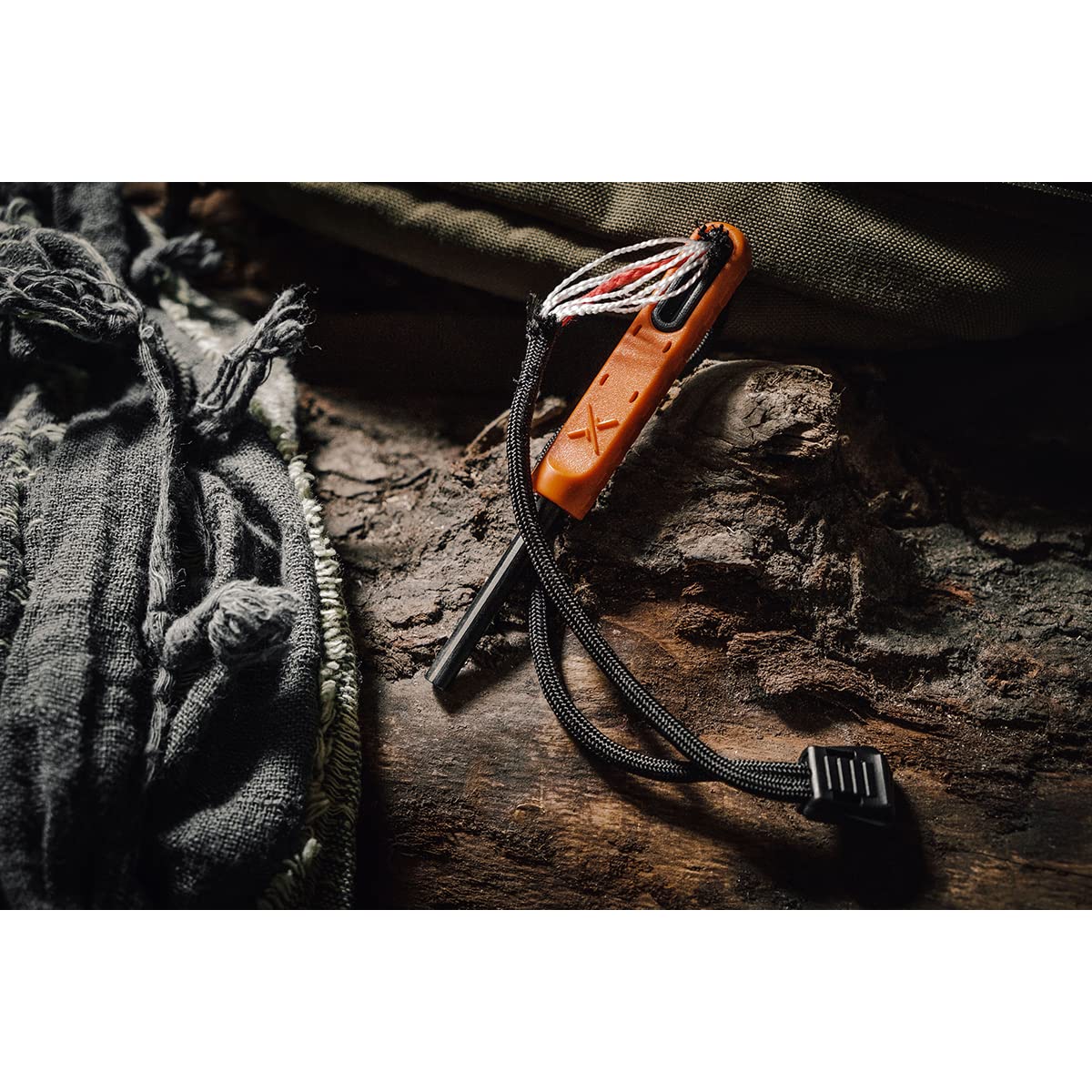 Exotac polySTRIKER in-use camping scenario showing campfire ignition