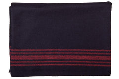 Farm Blue Wool Blanket folded in navy with red stripes, ready for quick warmth on the go.