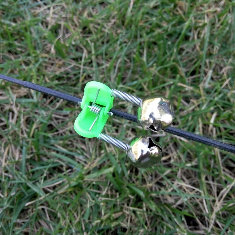 Bank fishing setup with ground pole holders on sand and mud