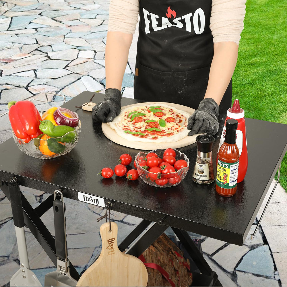 Feasto folding grill table with X-legs for stability during grilling.