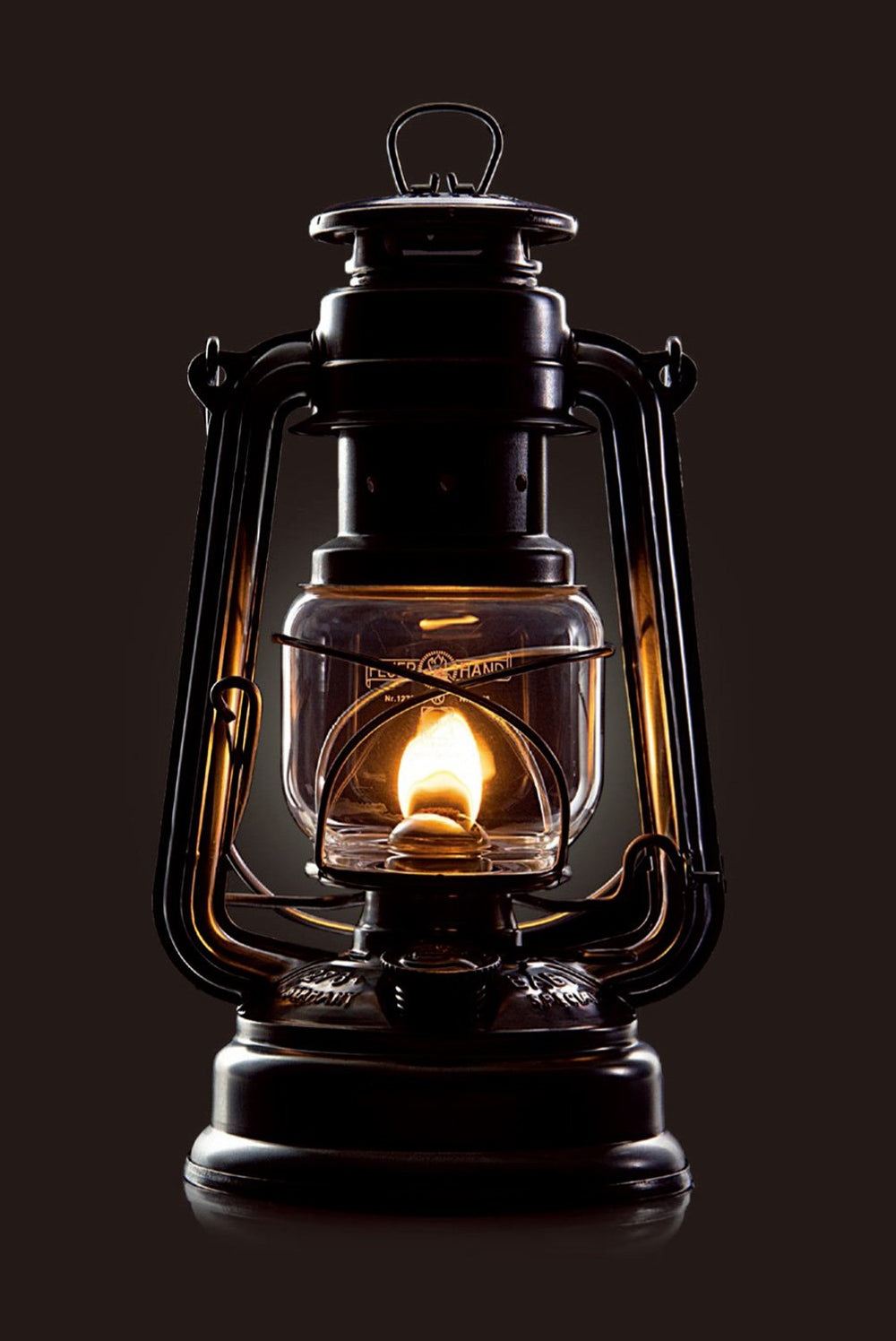 Feuerhand Baby Special 276 olive lantern at dusk with warm glow.