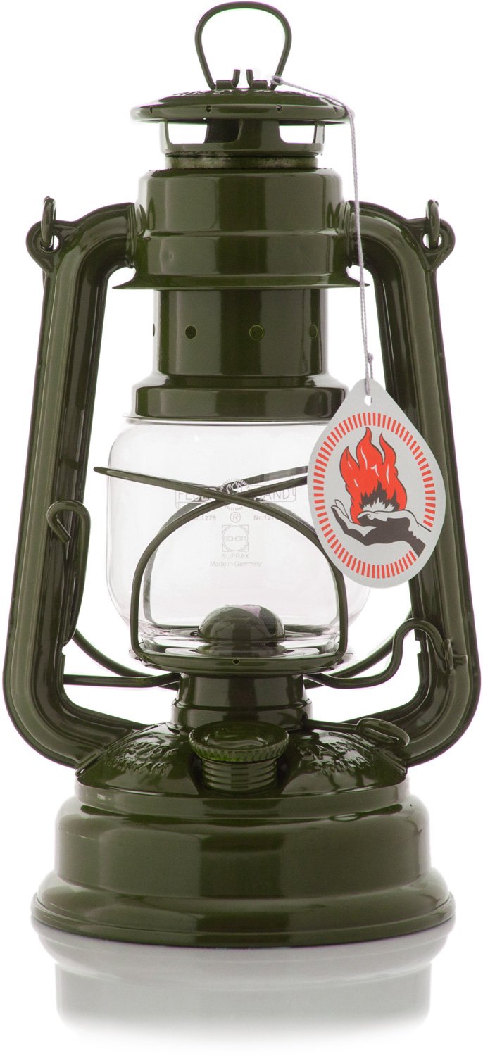 Feuerhand Baby Special 276 olive lantern on table, cozy outdoor lighting setup.