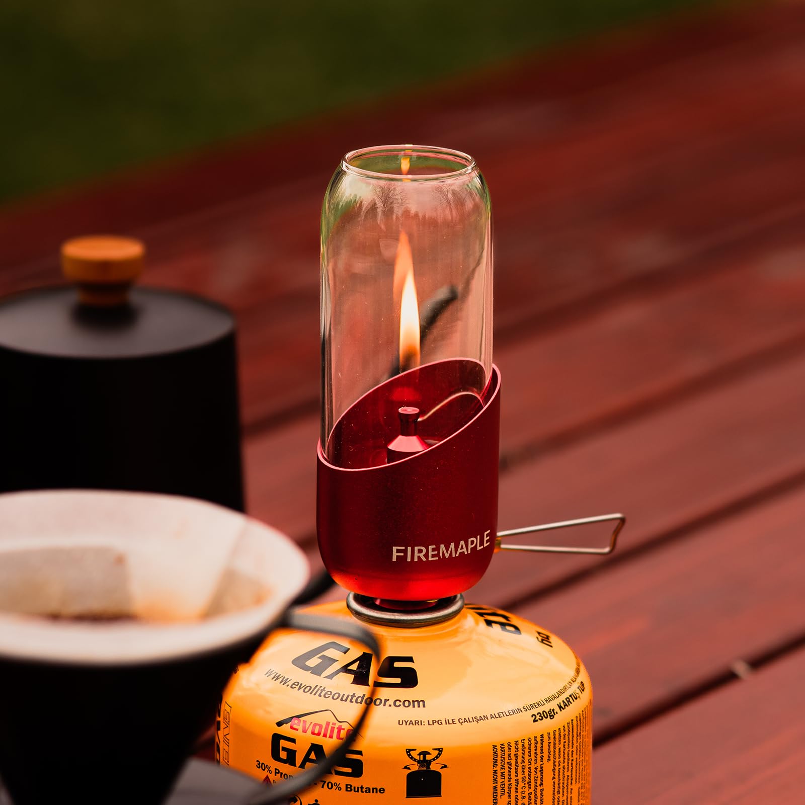 Fire-Maple orange camping lantern fuel connection for quick setup with gas canisters.