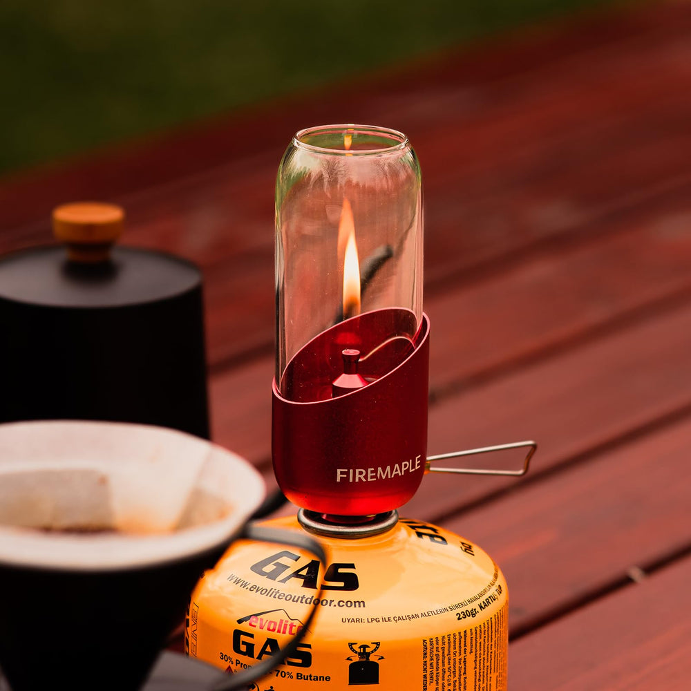 Fire-Maple orange camping lantern fuel connection for quick setup with gas canisters.