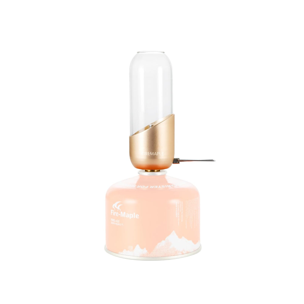 Fire-Maple orange camping lantern glass globe emits warm glow for outdoor ambiance.