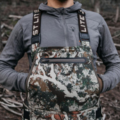First Lite Sanctuary 2.0 full-side zipper bib pant enabling easy on and off at the stand.