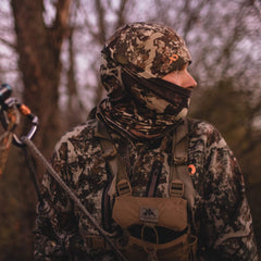 First Lite Aerowool neck gaiter conifer packaging shot emphasizes ultralight wear for active sessions.
