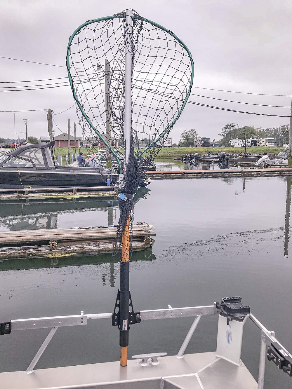 Fish Fighter Net Holder mounted to rail slider for secure storage and quick retrieval.