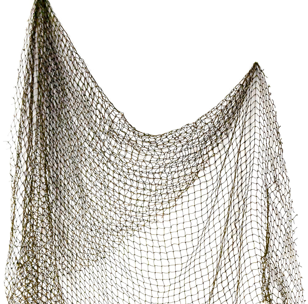 Repurposed 5x10 ft fishing net draped on wall for nautical decor