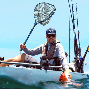 Blue foldable fishing net in water catching fish
