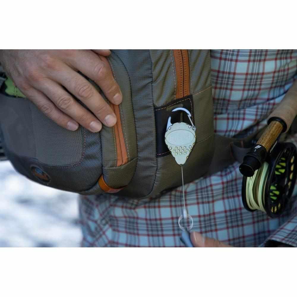 fishpond Arrowhead retractor attached to a pack via carabiner clip.