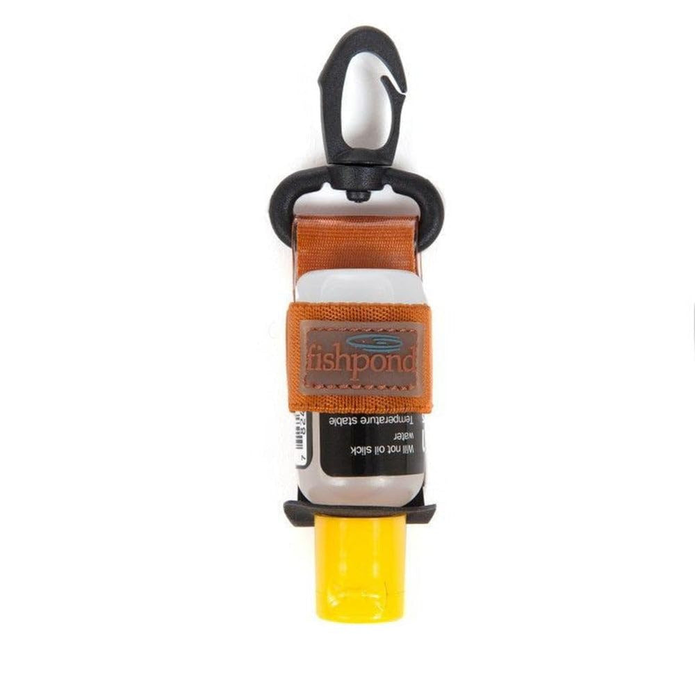 Fishpond Floatant Bottle Holder clipped to vest for quick access on fishing trips.