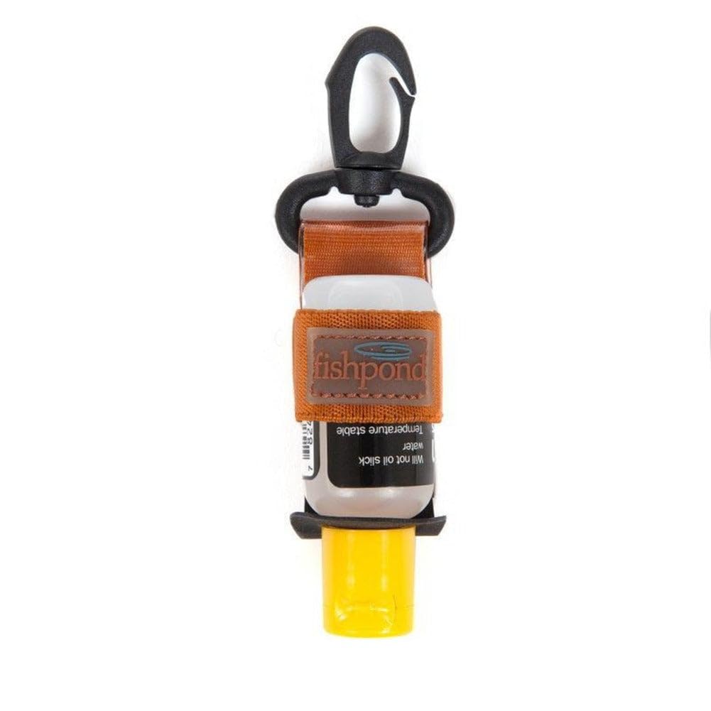 Fishpond Floatant Bottle Holder clipped to vest for quick access on fishing trips.