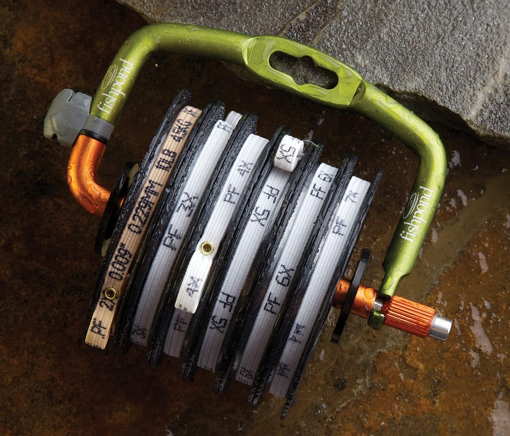 Angler accessing a tippet spool from the Headgate