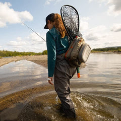 fishpond Summit 2.0 sling pack back with net sleeve supports easy storage while casting.