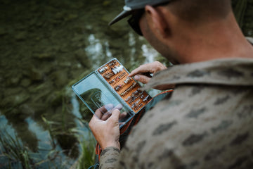 Durable materials of Fishpond Tacky Original Fly Box in rugged use imagery