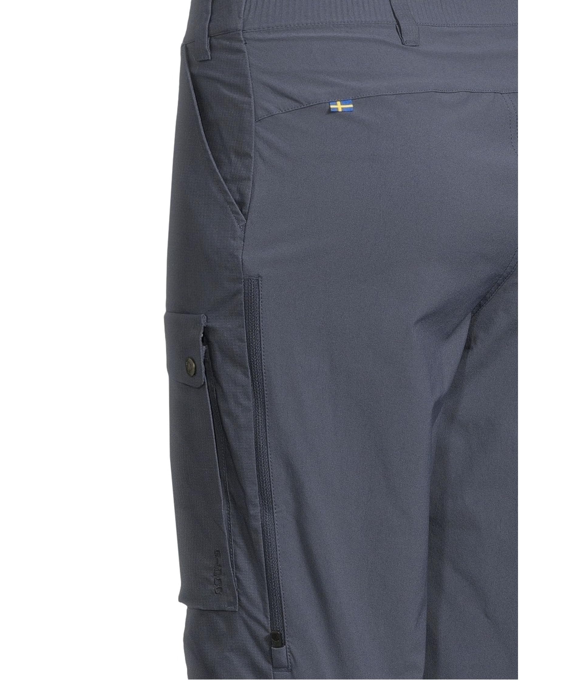 Fjällräven Abisko Hybrid Trail Trousers worn in forest scene demonstrating rugged fabric