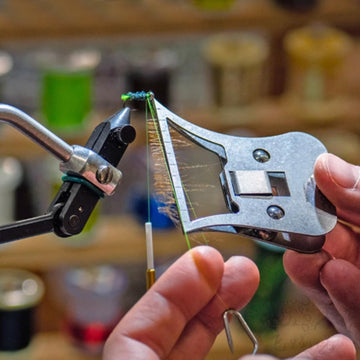 Close-up of metal feather pliers for fly tying