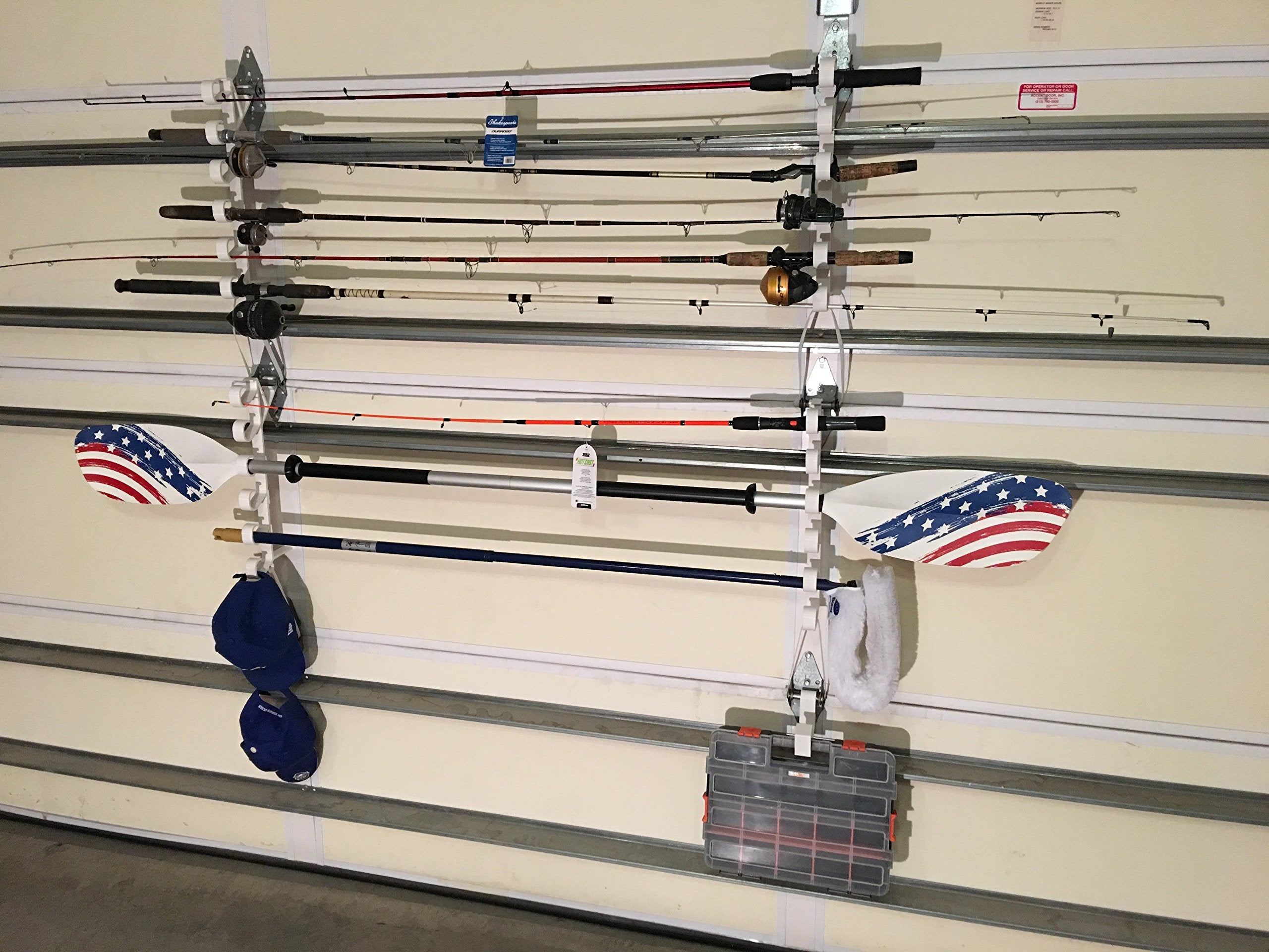 Garage door storage rack mounted on a hollow hinge