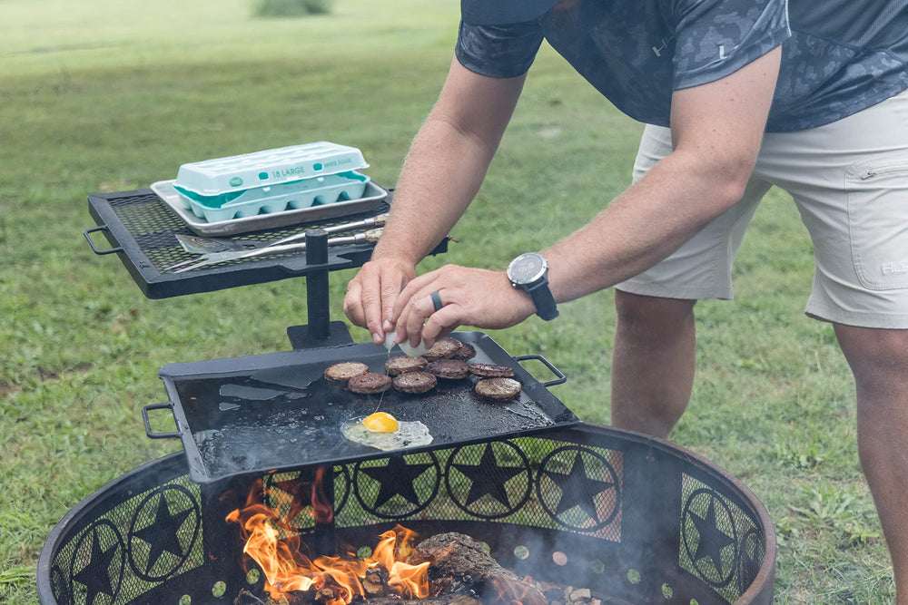 GameMaker grill and skillet combo cooking over a campfire for quick meals.