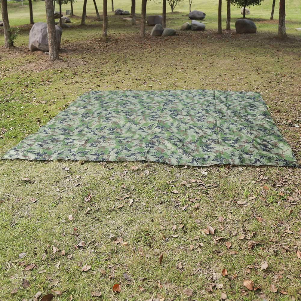 Gavigain camo bushcraft tarp camping scene offers versatile protection for outdoor use.