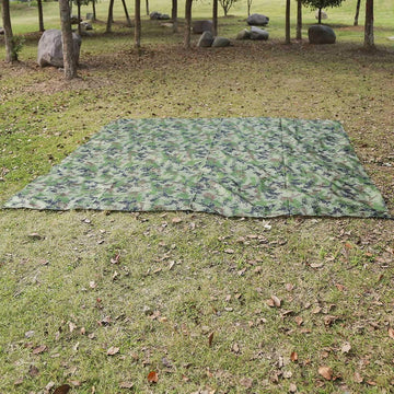 Gavigain camo bushcraft tarp camping scene offers versatile protection for outdoor use.