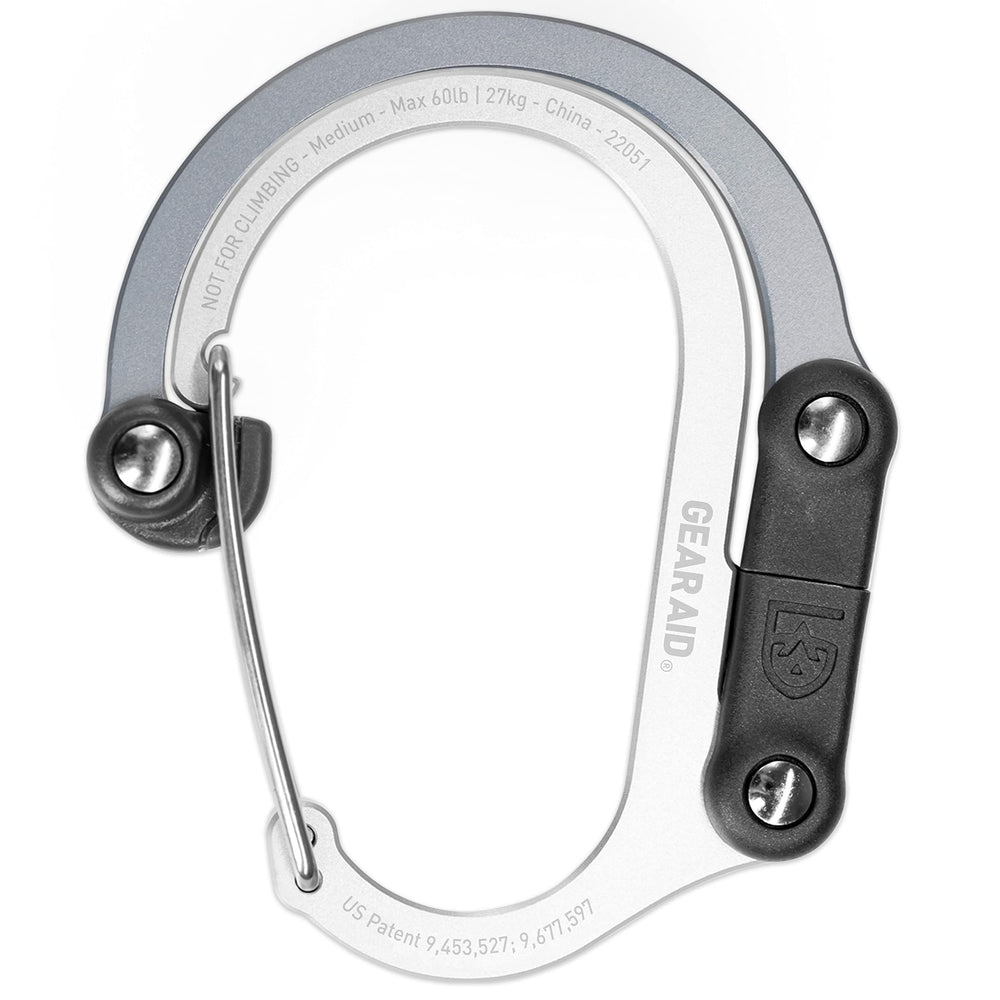 GEAR AID HeroClip Medium keeps a duffle bag organized on a fence