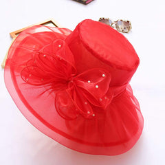 Generic red wedding hat with flower fascinator, elegant cloche style for church ceremonies.
