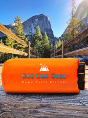 Get Out Gear Down Blanket folded compactly, ready for backpacking adventures.