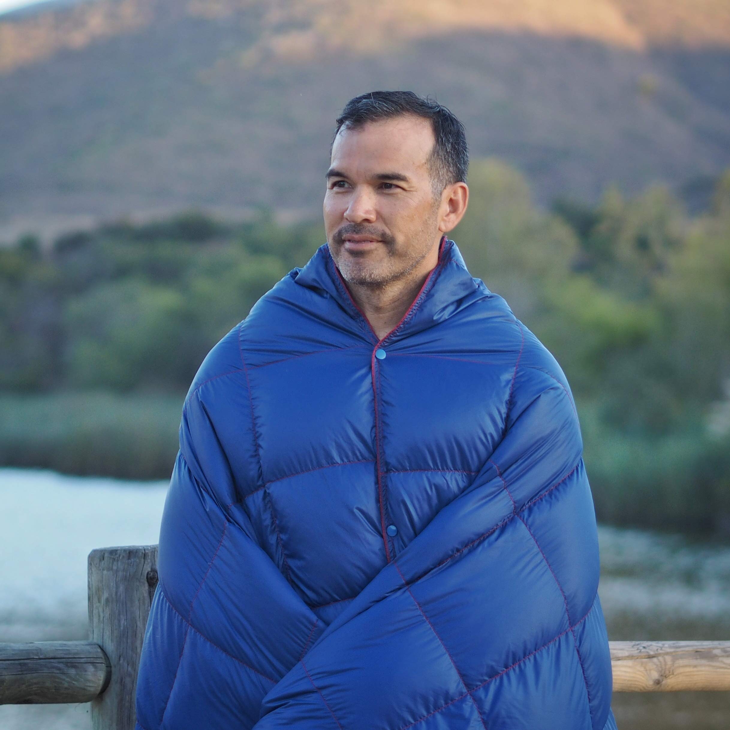 Get Out Gear down camping blanket draped over a hammock for cozy outdoor warmth.