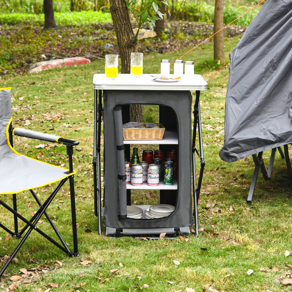 Giantex folding cabinet with 3 shelves inside keeps kitchen essentials organized during picnics.