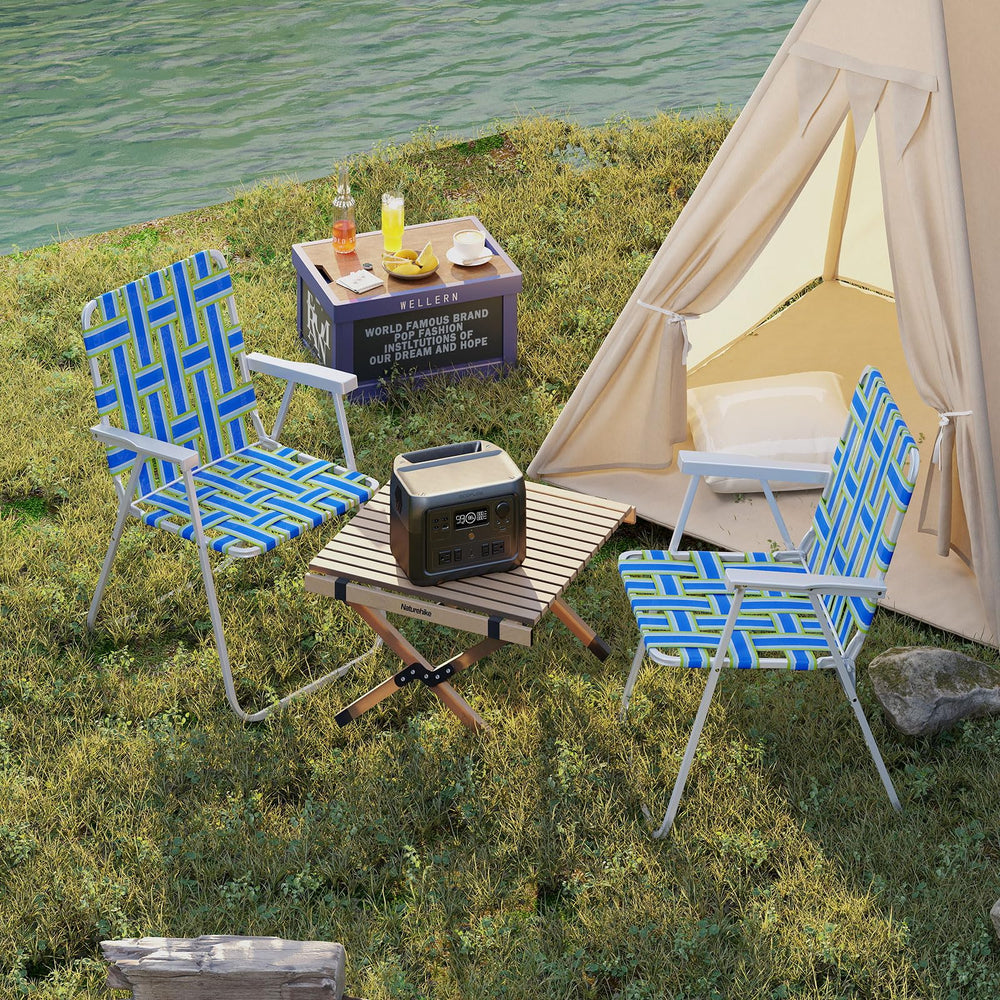 Giantex blue chair in use at a picnic, showing back tilt and armrests