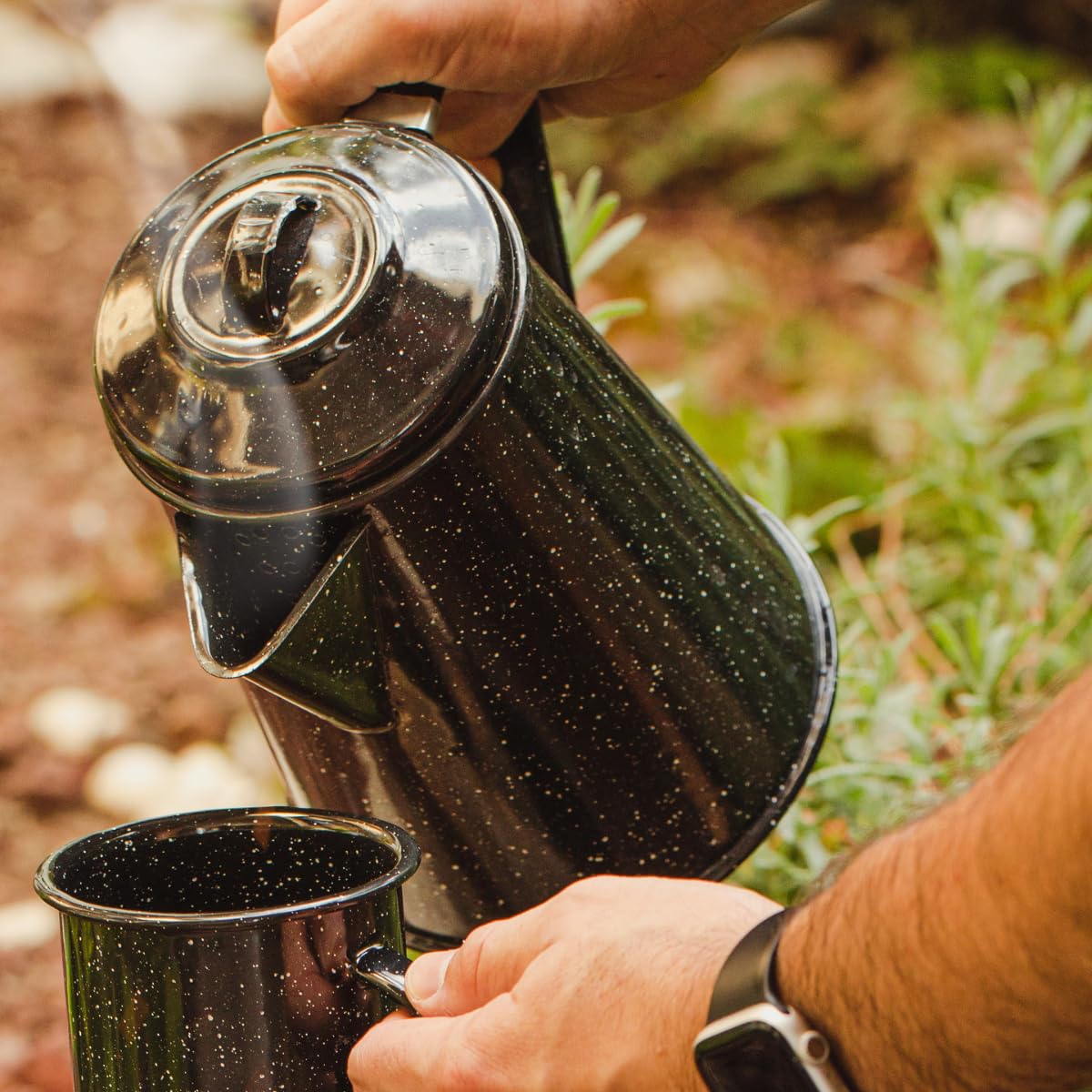 Granite Ware coffee boiler over campfire for warm outdoors coffee