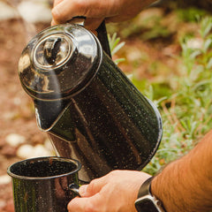 Granite Ware coffee boiler over campfire for warm outdoors coffee